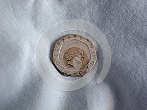 Sterling 20p coin on linen