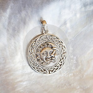Sterling siver pendant on white shell background