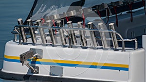 The stern of a boat with a bullbar of fishing rod holders