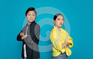 Stern-faced man and woman with arms crossed, showing a defiant or confrontational attitude photo