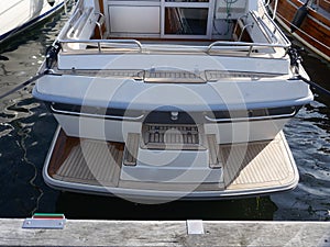 Stern of a luxury motor yacht. Details, bathing platform, teak, stainless steel railing. Germany, Europe, Heiligenhafen