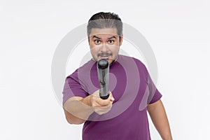 A stern man pointing at someone with a baton, giving a warning. Hostile person with a blunt weapon. Isolated on a white background