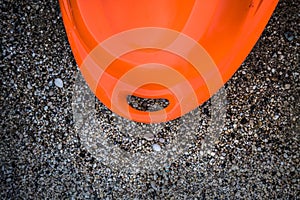 Stern the Rear End of Watercarft on Stony Sand. Fun and Adventure for Outdoor Extreme Watersport. Orange kayak Back Part