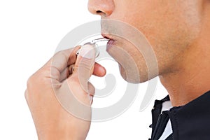 Stern referee blowing his whistle