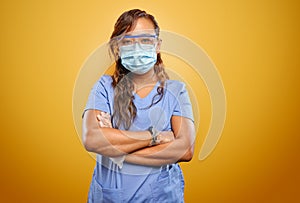 Stern and strong filipina nurse with arms crossed wearing PPE
