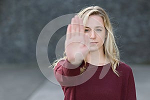 Stern young woman making a stop gesture