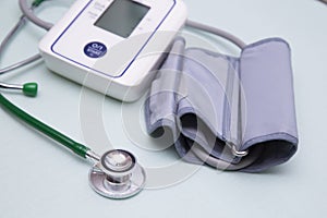 Stethophonendoscope and blood pressure meter on a green background.Concept of medical services and insurance of medical services