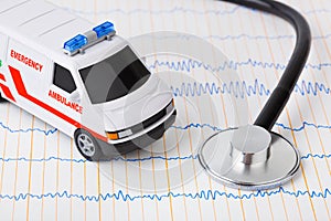 Stethoscope and ambulance car on ecg