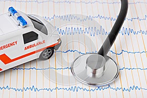Stethoscope and ambulance car on ecg
