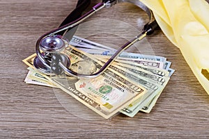 Stethoscope on american money dollar bills. Medical services, health insurance cost concept