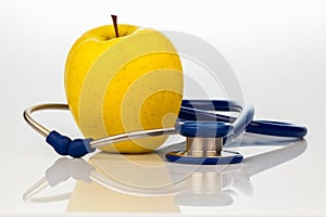 Stethoscope and apple. healthy eating