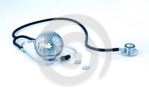 Stethoscope around a globe made out of puzzle