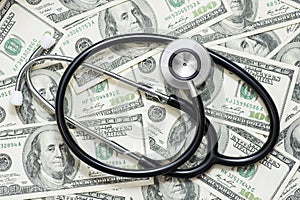 Stethoscope on the background of dollar bills. The concept of paid medicine. Medical costs. Healthcare payment concept