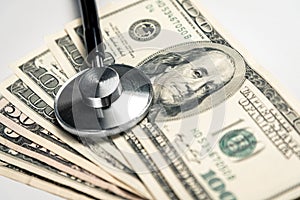 Stethoscope on a background of money - a business concept in medicine, a bribe to a doctor. Horizontal frame