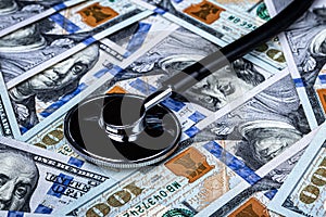 Stethoscope on the background of one hundred dollar bills