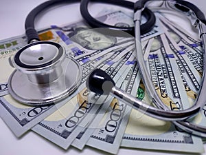 Stethoscope on the background of US dollar bill. The concept of paid medicine. Medical cost. Healthcare payment system