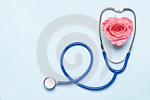 Stethoscope and beautiful rose heart on blue background. Thank You heroes Doctor and Nurses concept