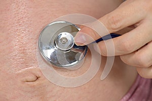 Stethoscope on belly