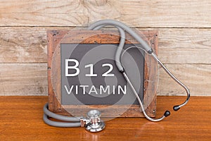 stethoscope and blackboard with text & x22;Vitamin B12& x22; on wooden background