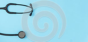 Stethoscope on blue background. Medical background. Doctor equipment. Health care concept. Copy space, top view