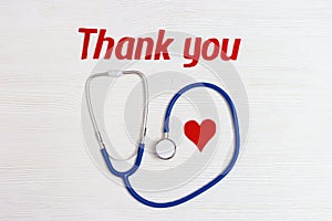 Stethoscope blue colored, red heart and text thank you.Healthcare and medical concept. World health day