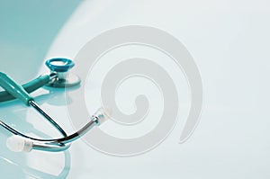 Stethoscope on blue, reflective background