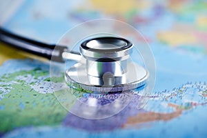 Stethoscope with blur world map at United states of america