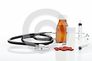 Stethoscope with bottle of medicine,feeding syringe,capsule on w