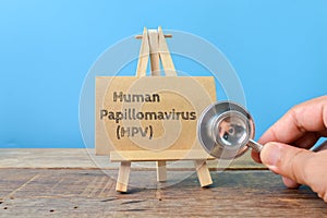 Stethoscope and brown card written with text HUMAN PAPILLOMAVIRUS HPV