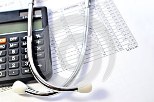 Stethoscope and calculator symbol for health care