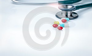 Stethoscope, capsule, and tablets pills on doctor table or nurse desk. Health checkup. Medical healthcare and medicine background