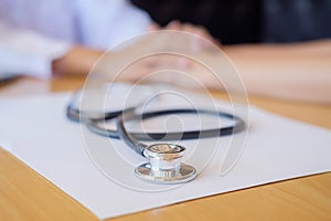 Stethoscope with clipboard and Laptop on desk Doctor working in