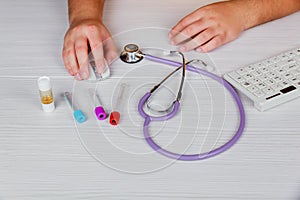 Stethoscope with clipboard and Laptop on desk,Doctor working in hospital writing a prescription,