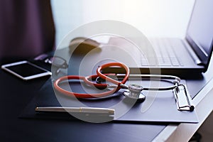 Stethoscope on clipboard and laptop with item,Healthcare and medical concept