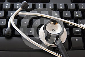 Stethoscope by a computer keyboard