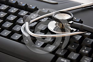 Stethoscope by a computer keyboard