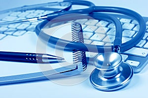 Stethoscope. Computer keyboard. Notebook