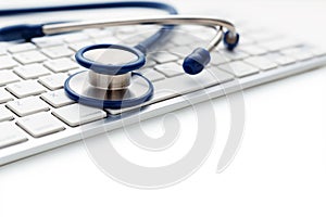 Stethoscope on computer keyboard on white background