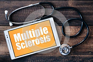 Stethoscope and digital tablet with MULTIPLE SCLEROSIS word on it screen