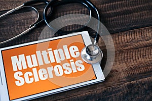 Stethoscope and digital tablet with MULTIPLE SCLEROSIS word on it screen photo
