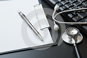 Stethoscope, Document Board, Keyboard computer, Notebook, Pen  on black background and copy space