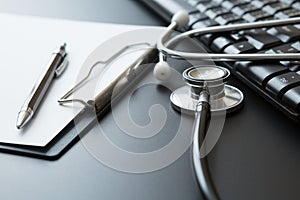 Stethoscope, Document Board, Keyboard computer, Notebook, Pen  on black background and copy space