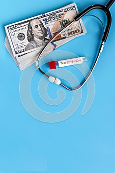 Stethoscope and dollars. Health costs during the epidemic of the coronavirus. Concept of payment for medical services in a crisis
