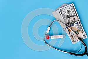 Stethoscope and dollars. Health costs during the epidemic of the coronavirus. Concept of payment for medical services in a crisis