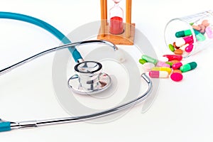 Stethoscope and drug pill with hourglass concept for doctor and medical nursing people check up healing of patients