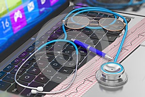 Stethoscope and ECG on laptop keyboard