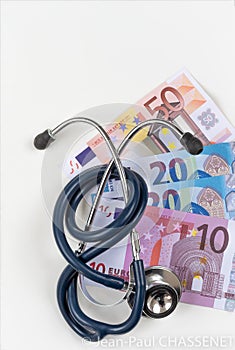 stethoscope and euro banknotes, symbolic photo for cost of healtcare