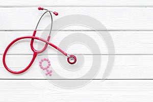 Stethoscope and female symbol for diagnostic and cure of gynaecological disease on white background top view mockup