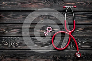 Stethoscope and female symbol for diagnostic and cure of gynaecological disease on wooden background top view mockup