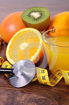 Stethoscope, fresh fruits, juice and centimeter, healthy lifestyles and nutrition